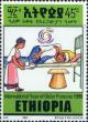 Colnect-3337-025-Woman-attending-to-sick-man.jpg