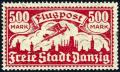Colnect-1607-911-Airplane-flying-over-the-silhouette-of-the-skyline-of-Danzig.jpg